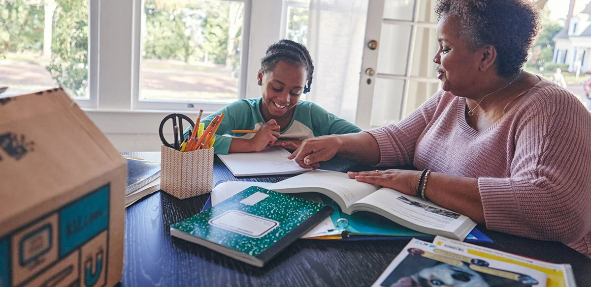 teacher with student looking the notebook