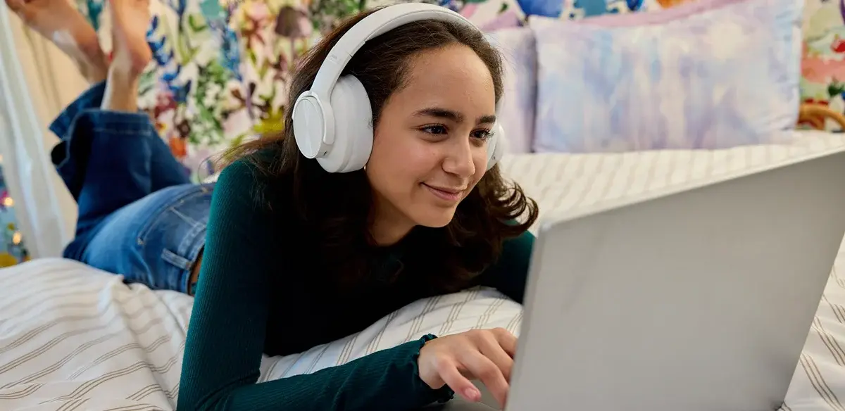 girl using her computer with headphones